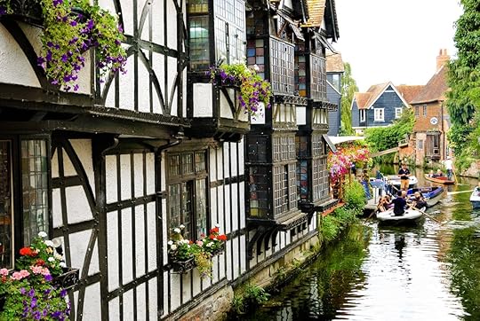 Tourist enjoying punting guided-tour in the heart of old Canterbury
