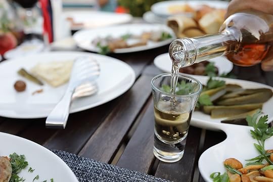 Waiter pouring chacha into glasses in cafe