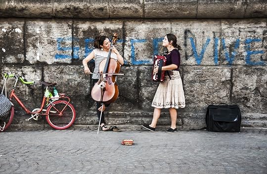 two young musicians play music on the street in Naples
