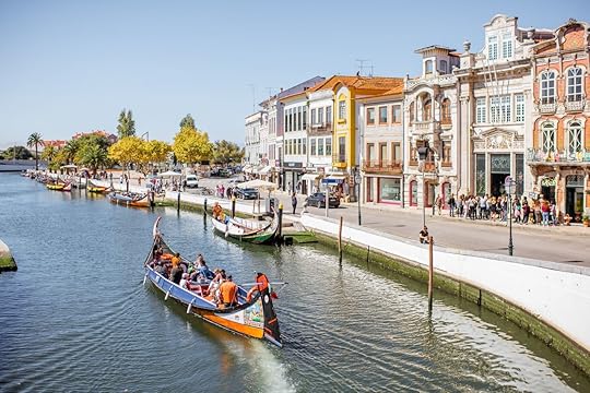 View on the water channel with boats and colorful old buildings in Aveiro city in Portugal