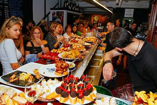 Young girls look at the bar tops of a bar of San Sebastian