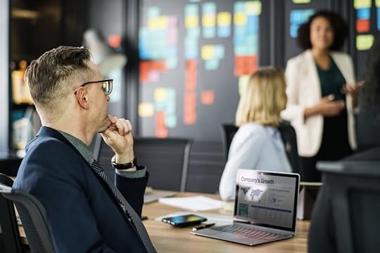 Male leader thinking about other careers while sitting in business meeting