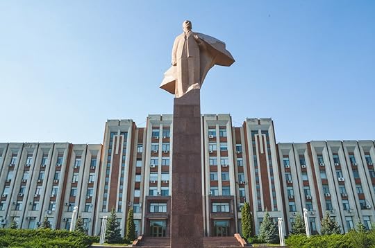 Statue of Lenin, Brutalist architecture, and flag with Soviet emblems in Tiraspol