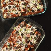two pans of chicken and chile enchiladas