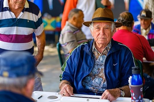 elderly man plays the domino game in the historic Domino Park in popular Little Havana