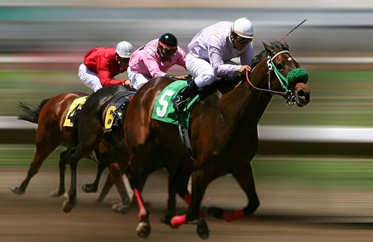 Three racehorses speeding around a track