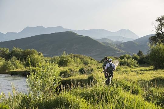 A fly fishing guide with clients on the Provo River near Midway, Utah.