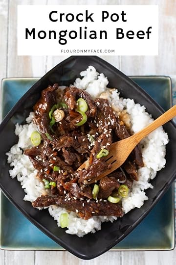 a black and turquios bowl filled white cooked white rice and tender Crock Pot Mongolian Beef