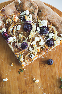 Blueberry Goat Cheese Pizza with Caramelized Onions and Rosemary/Photo by Brent Harrewyn