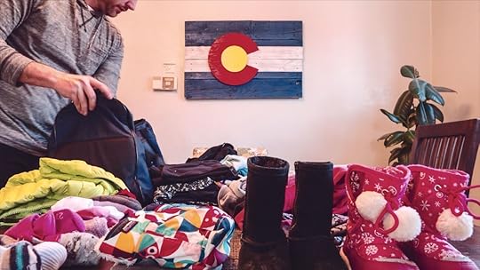 Dad packing for a trip with his toddler