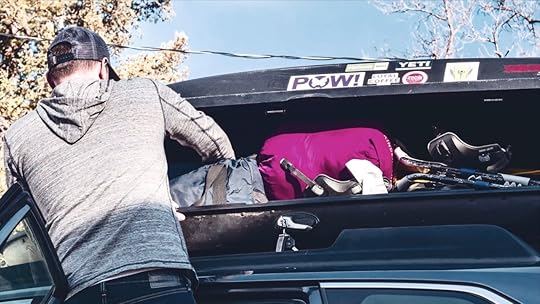 Dad packing a car for a trip with his family