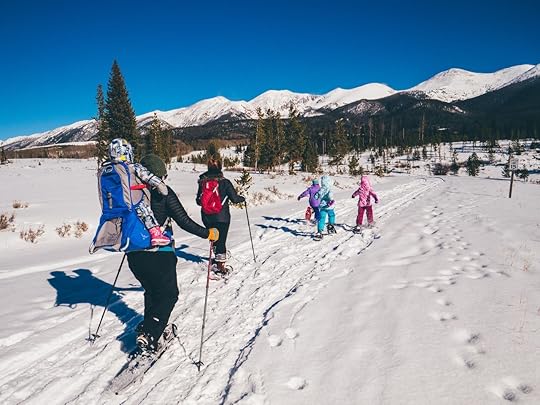 Family cross country skiing in the mountains