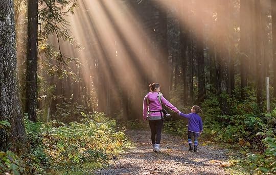 Mom and daughter walking though the woods