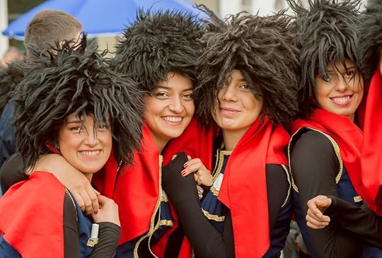 Happy faces of young girls in traditional Georgian costumes