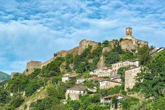 Gjirokaster Castle and clock tower with Ottoman Houses below in Gjirokaster, Albania