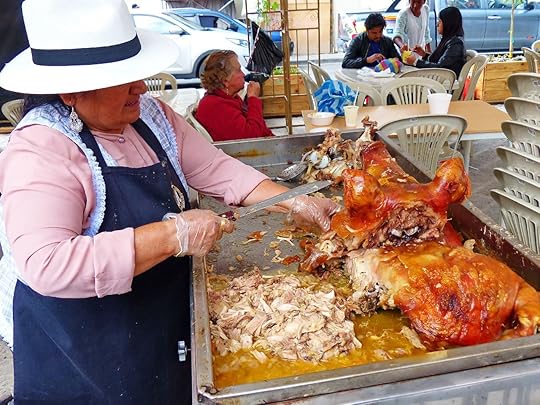 Woman selling sellling roasted pig in an Ecuadorian plaza