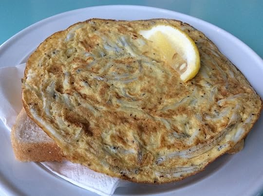 Whitebait fritter with bread and lemon wedge in New Zealand