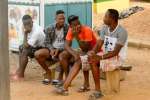 AFRICAN FICTION, WESTERN READERS: Young Ghanaian men having a discussion (Shutterstock/Anton Ivanof)