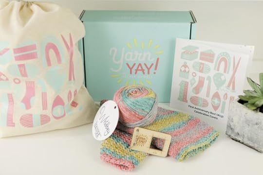 YarnYAY! Anniversary Box | Includes Anniversary Cowl knit and crochet patterns, Whidbey yarn exclusive YarnYAY! self-striping colorway, cotton backpack with artwork by Anda Corrie, and Katrinkles gauge keychain.