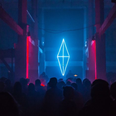Worshippers or concert goers gaze at lighted diamond