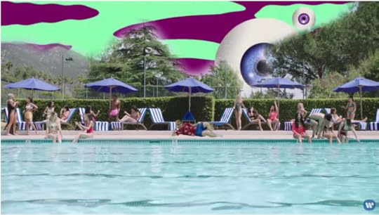 Ed is green-screen lounging pool-side in the damn socks, shorts a dad would wear, and a flowered button-down shirt. The sky is purple and green and there is a giant, floating CGI eyeball.