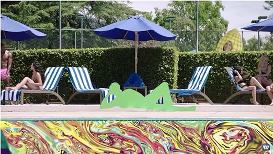 The same pool scene, but now the water is a mass of swirling colors, Ed is a green silhouette, and Justin Bieber is a corn-on-the-cob bouncing merrily around in the background.