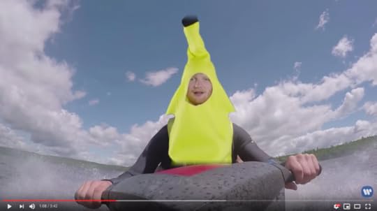 Ed is wearing a banana suit. He is (green screened) onto a jet ski. 