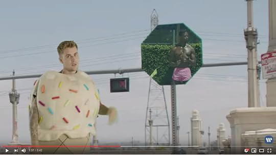 Now, Beebs is dressed like an ice cream cone, superimposed over a street with a traffic signal in the background and a stop sign that has been made into a window on the pool party scene, framing a sexy, shirtless, absolutely fucking ripped black guy.
