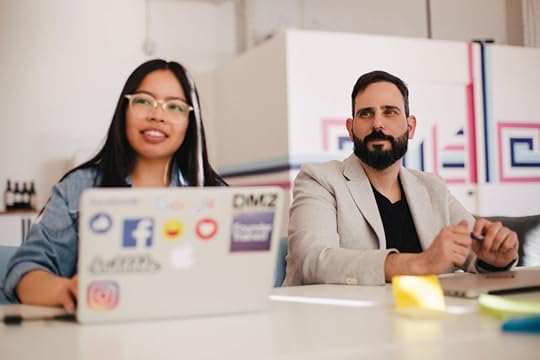 Two employees talking at conference table