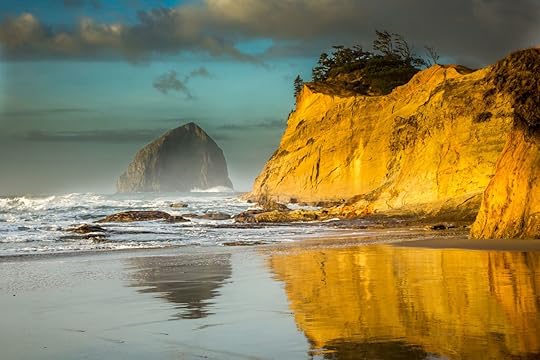 Cape Kiwanda and Haystact Rock reflected the the wet sand on the beach at Pacific city on the Oregon coast