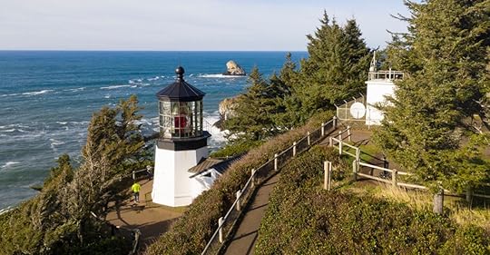Pacific Ocean waves crash against high bluffs below Cape Mears Lighthouse