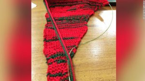 Sue Montgomery knitting - men & women talking in council meeting