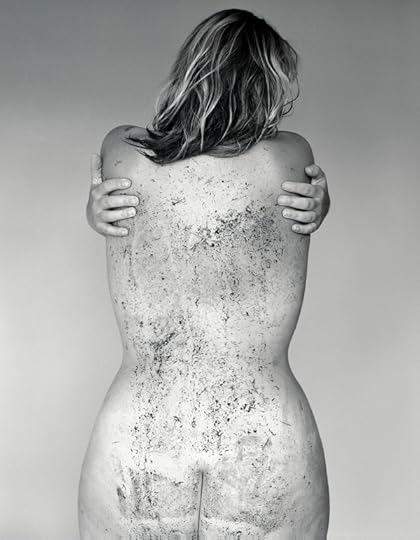 Black-and-white studio portrait of a female subject's back