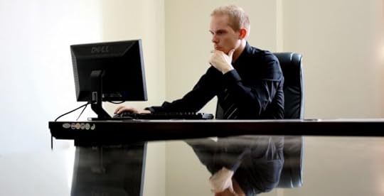 Lonely man sitting at desk at work
