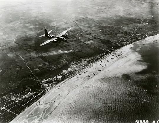 US B-26 Marauder over Utah Beach, 6 June 1944. The medium bomber has been specially marked for D-day with black and white stripes on the fuselage and wings, which were to identify itself as a friendly aircraft to ground units. (USAF photo)