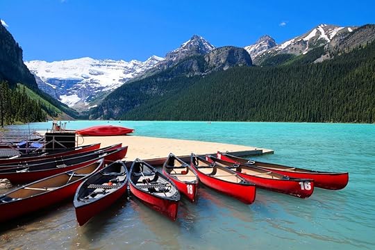 Red canoes in the blue waters of Lake Louise, Banff National Park, Alberta, Canada