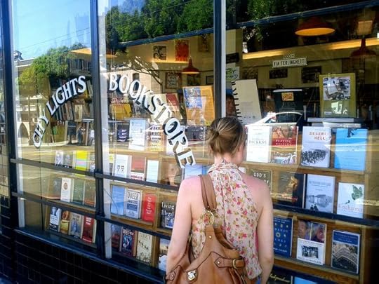 woman walking by independent bookstore, City Lights Bookstore in San Francisco