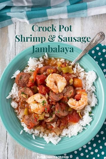 a teal bowl filled with Crock Pot Shrimp and Sausage Jambalaya served over white rice.