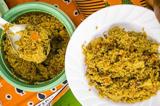 African woman putting pilau on white plate in Kenya