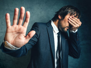 Sneaky ways you might be abused man holding hand over his face