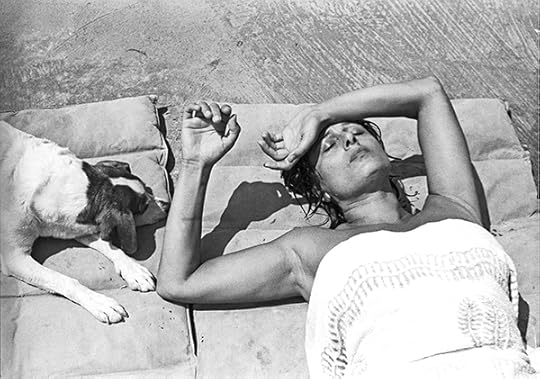 Paolo Di Paolo, Anna Magnani at her villa in San Felice Circeo, Rome, 1955. Beautiful woman lying in the sun with a dog next to her.