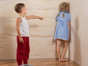boy putting girl in the corner