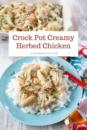 A light blue plate with a serving of Crock Pot Creamy Herbed Chicken on a bed of rice.