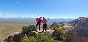 Lisa and Jen hiking with our Super Hero Capes at Tom's Thumb