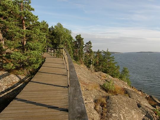 Wooden pedestrian path in pink granite rocks of Mariehamn, Aland archipelago, Finland