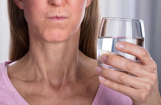 woman rinsing mouth with water