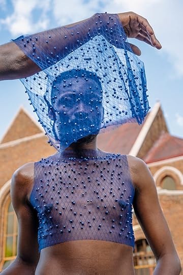 Jamal Nxedlana, FAKA Portrait, Johannesburg, 2019. Person in a mesh crop top. An arm above them drapes mesh in front of their face. 