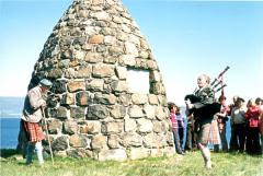 John MacFadyen piping at the MacCrimmon Cairn, Boreraig in 1974. Seton Gordon is on the left.