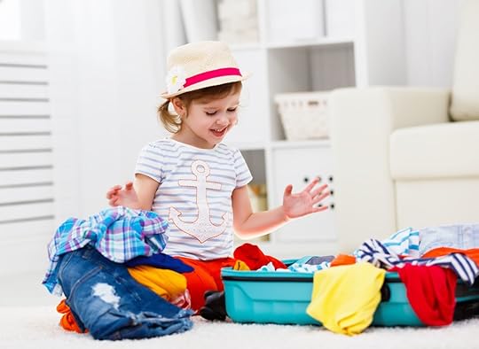 happy child packs suitcase