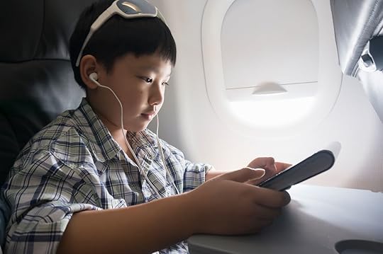 Child using a tablet on a plane